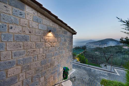 a brick wall with a light on the side of a building at Holidays Homes The dream in Sant'Agnello
