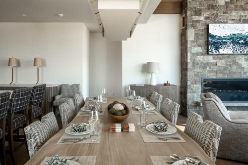 a dining room with a table and chairs and a fireplace at 9 Deep Forest Drive by Moonlight Basin Lodging in Big Sky