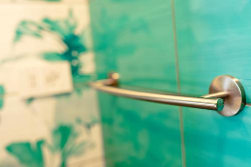 a shower door with a metal handle on a wall at Holidays Homes The dream in Sant'Agnello