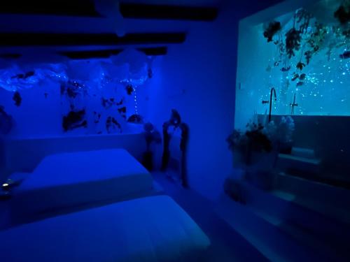a blue room with two beds and a aquarium at Hydria guest house art gallery in Acquaviva delle Fonti