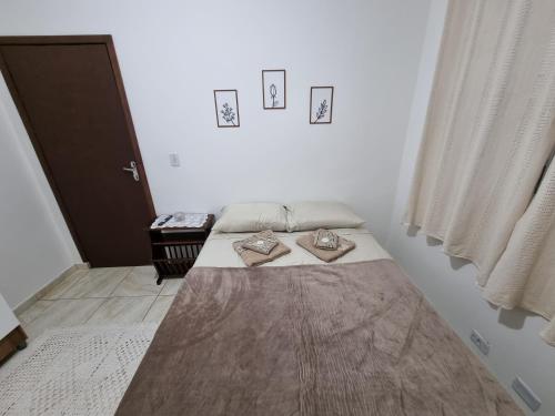 a bedroom with two beds in a room with a door at Studio Ideal in São Paulo