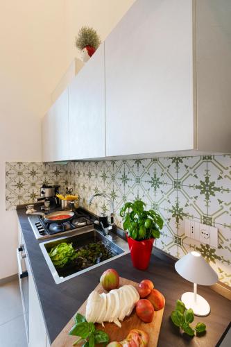a kitchen counter with a cutting board with fruits and vegetables at Holidays Homes The dream in Sant'Agnello