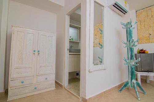 a room with a mirror and a white cabinet at CASA PLAYA JAMES in Los Arrayanes