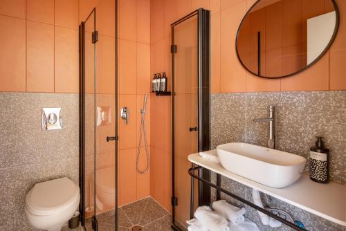 a bathroom with a shower and a sink and a toilet at Savanna Dizengoff - Smart Hotel by Loginn Tel Aviv in Tel Aviv