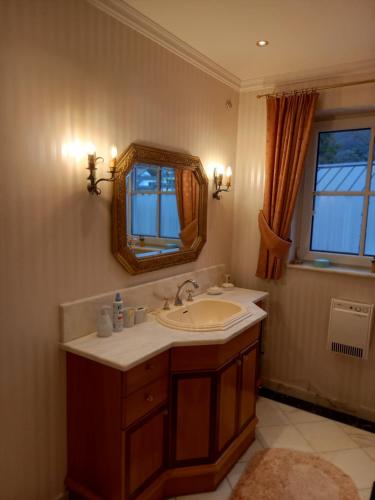 a bathroom with a sink and a mirror at Ferienhaus am Mondsee in Mondsee