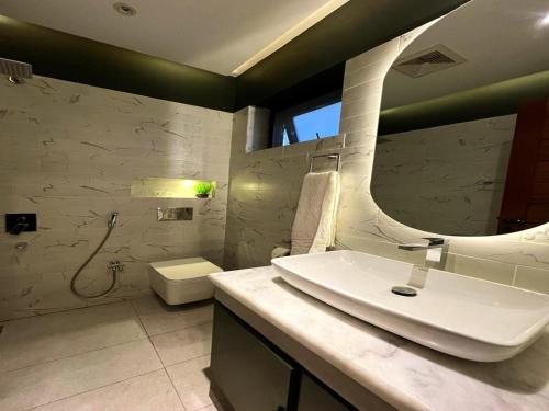 a white bathroom with a sink and a toilet at COMFORT & LUXURY HOME in Islamabad