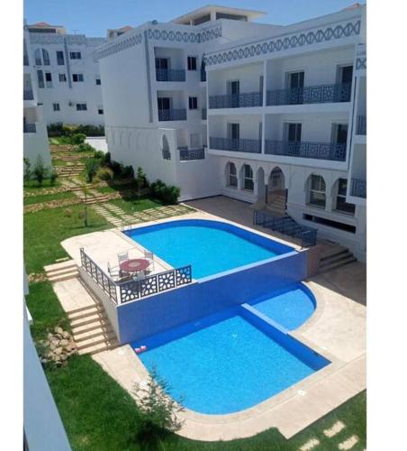 a large swimming pool in front of a building at Your privat peace place in Tangier