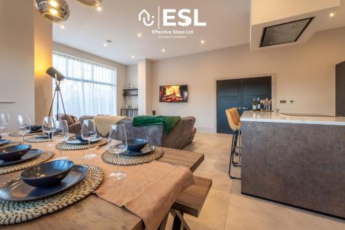 a living room with a table and a couch at Stunning 4 bedroom home in Chester