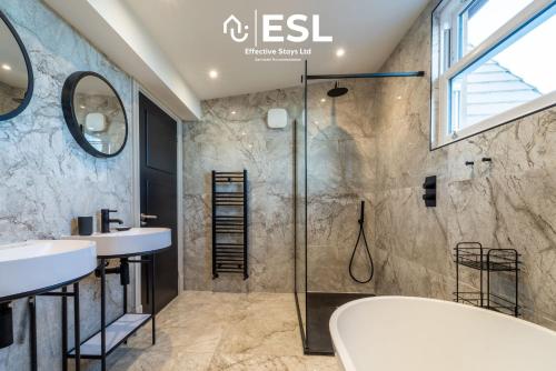 a bathroom with two sinks and a shower at Stunning 4 bedroom home in Chester