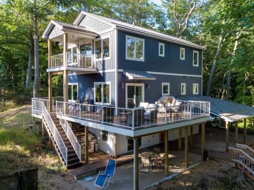 a modular home with a wrap around deck at Relax on Lake Michigan at Tranquil Shores in Norton Shores