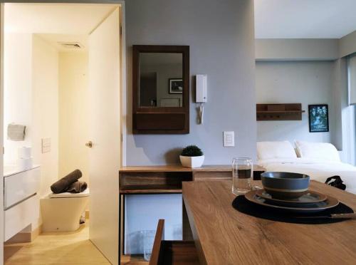 a room with a bed and a table with a bowl on it at Design Studio in Roma Norte - Walk Everywhere in Mexico City