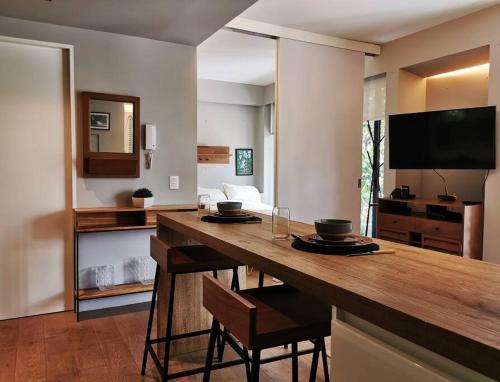 a living room with a table with two bowls on it at Design Studio in Roma Norte - Walk Everywhere in Mexico City