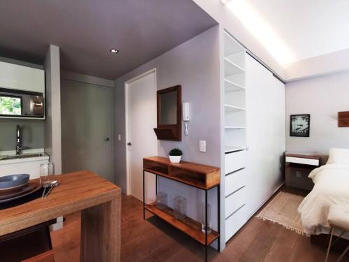 a bedroom with a bed and a desk in it at Design Studio in Roma Norte - Walk Everywhere in Mexico City