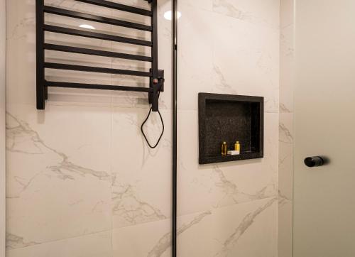a bathroom with a shower with a glass door at You Stay at Vila Olimpia - The World in Sao Paulo