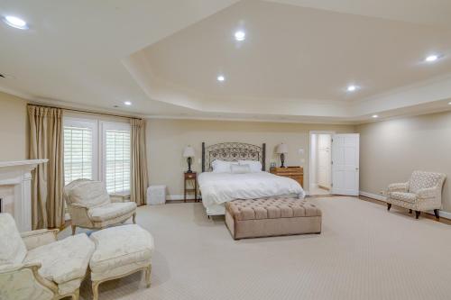 a large bedroom with a bed and two chairs at White Horse Farm with Hot Tub on 41 Acres! in Franklin