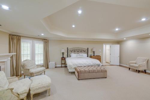 a large bedroom with a bed and two chairs at Pool, Hot Tub and Outdoor Theater Franklin Retreat in Franklin
