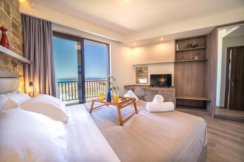 a bedroom with a large bed and a large window at Golden View Luxury Villa Platanias in Plataniás