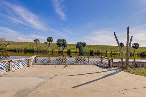 a walkway next to a river with a fence at Sun-Soaked Okeechobee Retreat with Canal Views! in Okeechobee