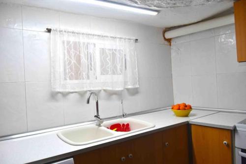 a kitchen counter with a sink and a window at LA CUEVA de TONI EL SECO in Paterna