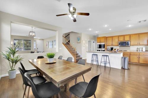 a dining room and kitchen with a wooden table and chairs at Seven Palms in Henderson