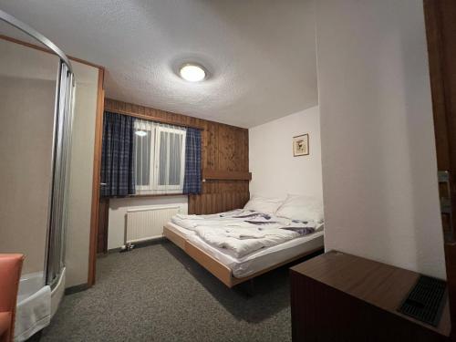 a small bedroom with a bed and a window at Romantic Room with private bathroom in Saas