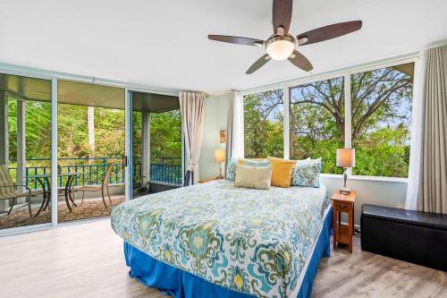 a bedroom with a bed with a ceiling fan at Mauna Loa Village with Pools, Tennis & Pickleball in Kailua-Kona