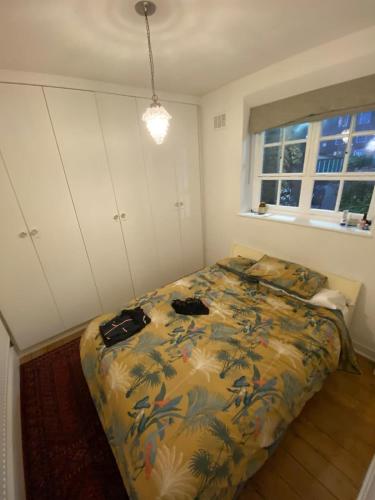a bedroom with a bed with two bags on it at Trendy 1BD Flat - 5 mins to Cambridge Heath! in London