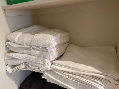 a pile of white towels in a closet at Luxury 2 bedroom apartment in downtown LA! in Los Angeles