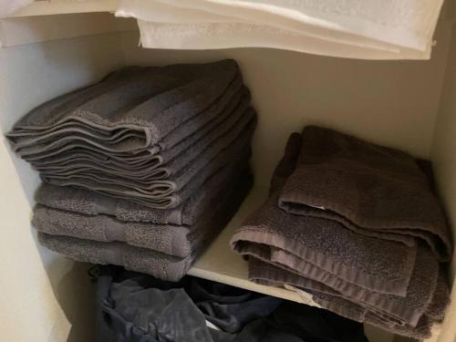 two stacks of towels on a shelf in a closet at Luxury 2 bedroom apartment in downtown LA! in Los Angeles