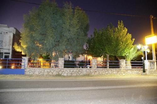 a fence on the side of a street at night at Holiday Tolofona Beach in Eratini