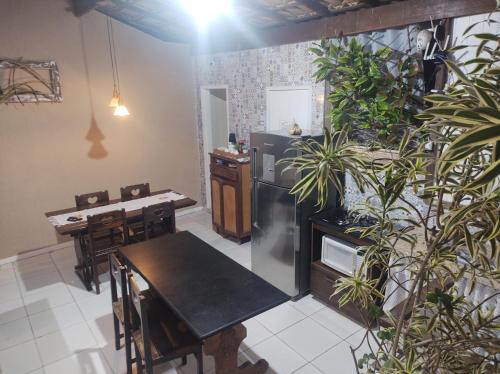 a kitchen with a table and some plants at Pousada nascente do sol in Macaé