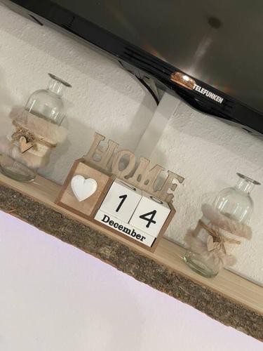 a shelf with a window with a clock on it at Boho Apartment Birkenstöckl in Bad Reichenhall