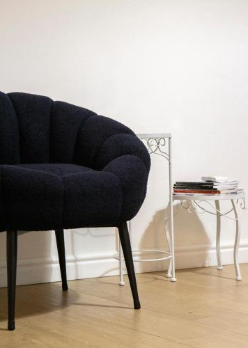 a blue chair sitting next to a side table at Palazzo Donnamaria in Manfredonia