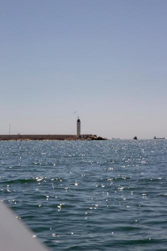 a lighthouse in the middle of a body of water at Palazzo Donnamaria in Manfredonia