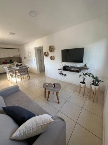 a living room with a couch and a table at Sarratea Guest in Godoy Cruz