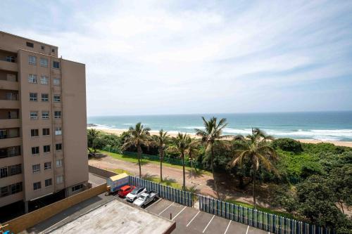 a view of the beach from the balcony of a building at Amanzi402 Oceanview Retreat in Amanzimtoti