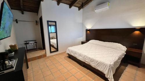 a bedroom with a large white bed in a room at La Peña Hotel Boutique & SPA in Cuetzalán del Progreso