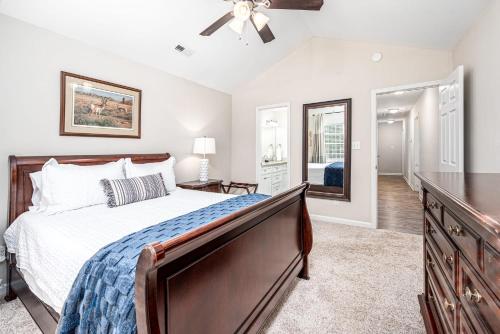 a bedroom with a bed and a dresser and a mirror at Cozy Pet friendly home-Raleigh in Raleigh