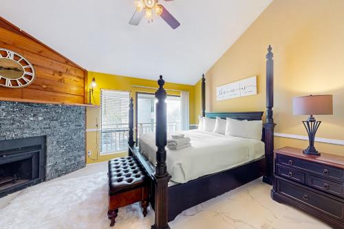 a bedroom with a bed and a fireplace at Ocean Mile B2 in St. George Island