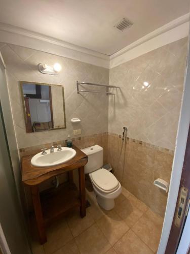 a bathroom with a toilet and a sink and a mirror at Complejo Refugios Marinos in Valeria del Mar