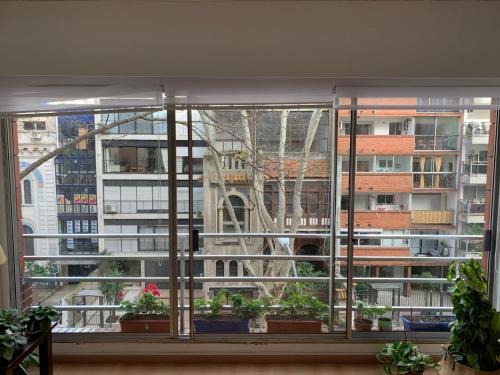 a large window with a view of a city at Apartamento en Pocitos in Montevideo