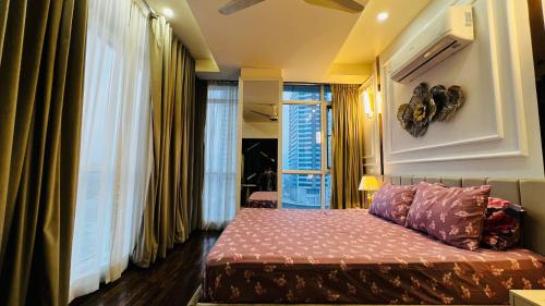 a bedroom with a bed and a large window at Sky Heights Luxury Apartments Facing Centaurus Mall Islamabad in Islamabad