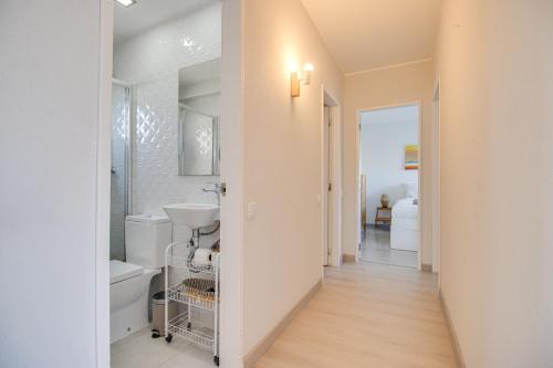 uma casa de banho branca com um lavatório e um WC em Lovely 3BD 150m Beach Ocean View AC Wi-Fi Balcony em Albufeira