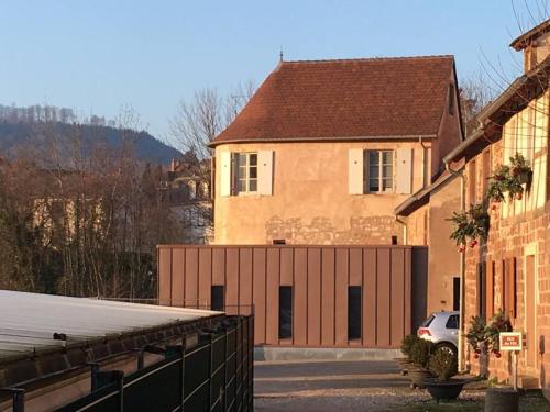 a house with a garage with a car parked in front at Gîte La Tour des Remparts Pool & Jacuzzi in Saverne