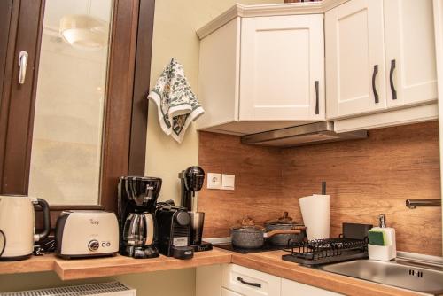 a kitchen with white cabinets and a counter top at Serenity by Elite Dwellings in Portariá