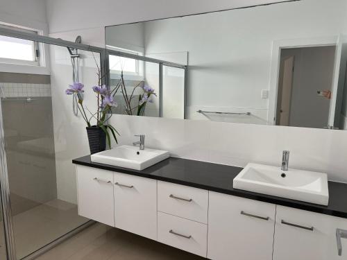 a bathroom with two sinks and a mirror at Sea Retreat - Esplanade Available Xmas 2023 and 2024 Summer in Robe