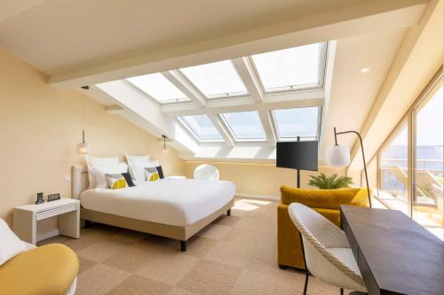 a bedroom with a bed and a table and chairs at Best Western Premier Montfleuri in Sainte-Maxime