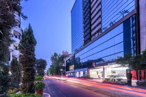a city street with a tall building and a building at NH Collection Mexico City Reforma in Mexico City