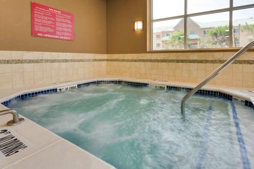 a jacuzzi tub with a shower in a bathroom at Drury Plaza Hotel Columbia East in Columbia