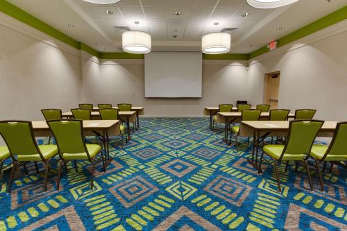 a conference room with tables and chairs and a whiteboard at Drury Plaza Hotel Columbia East in Columbia